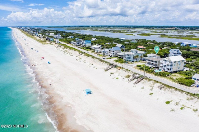 birds eye view of property with a water view and a view of the beach