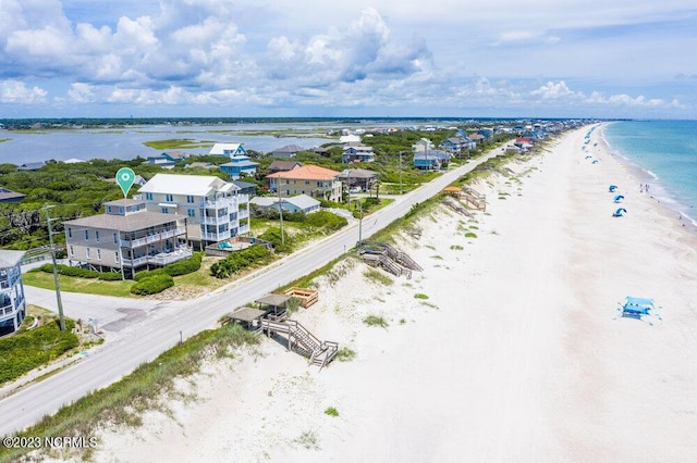 drone / aerial view with a water view and a beach view