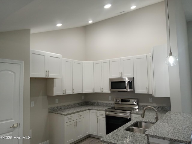 kitchen with sink, light stone countertops, decorative light fixtures, white cabinetry, and stainless steel appliances