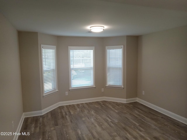 spare room featuring dark hardwood / wood-style floors