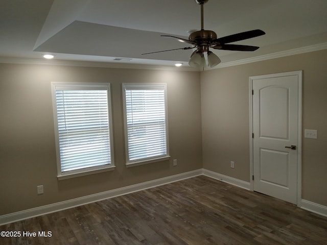 spare room featuring crown molding, ceiling fan, and dark wood-type flooring