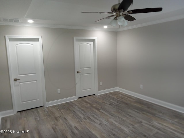 empty room featuring wood-type flooring, ceiling fan, and crown molding