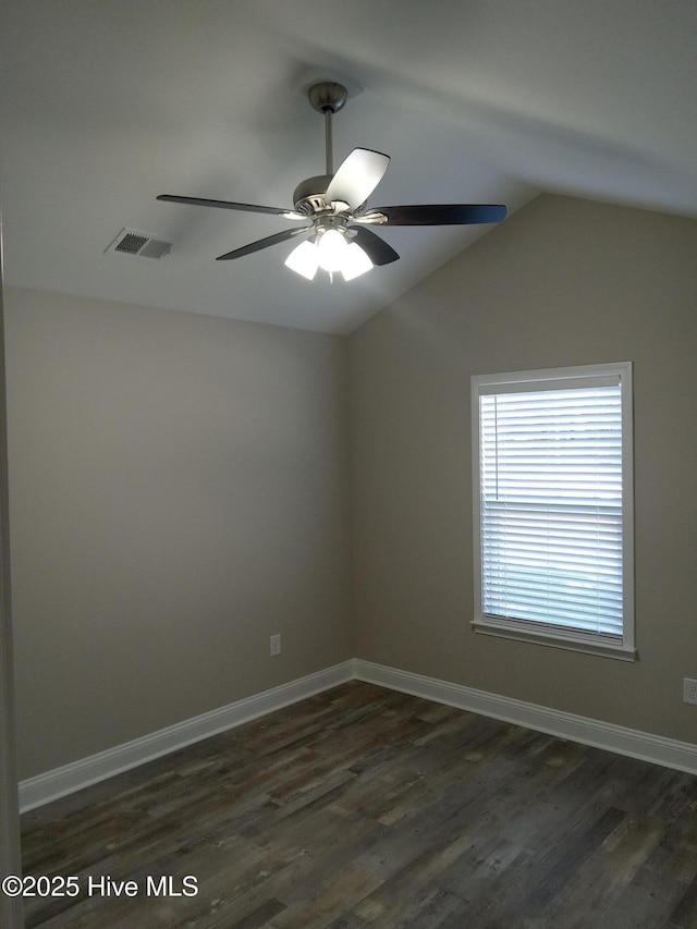 spare room with dark hardwood / wood-style floors, ceiling fan, and lofted ceiling