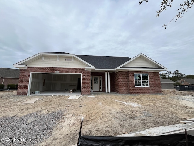 view of front of home with a garage and brick siding