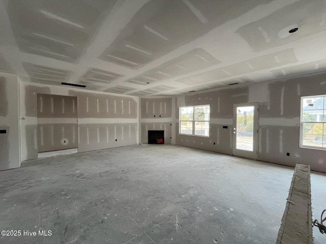 unfurnished living room featuring plenty of natural light