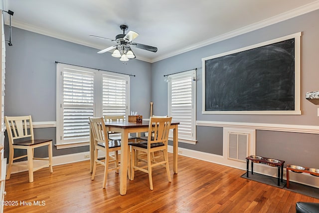 dining area featuring crown molding, ceiling fan, and hardwood / wood-style floors