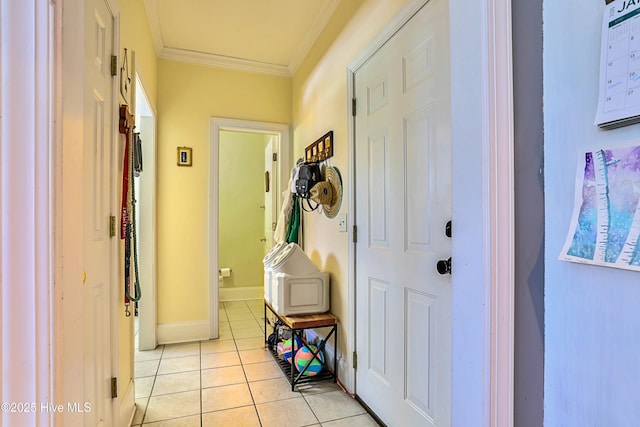 interior space with ornamental molding and light tile patterned floors