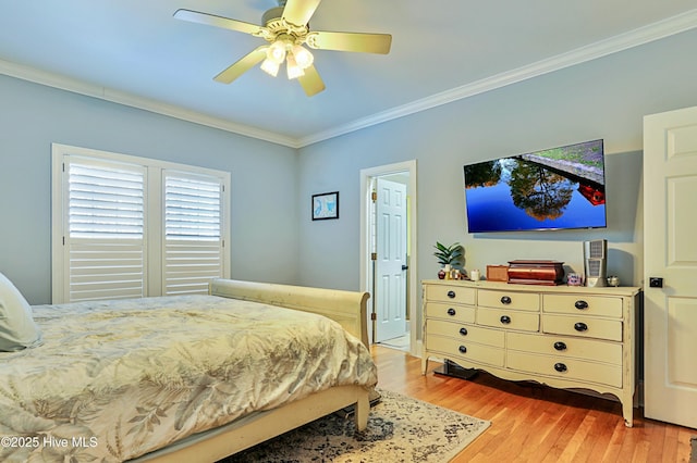 bedroom featuring light hardwood / wood-style flooring, ornamental molding, and ceiling fan