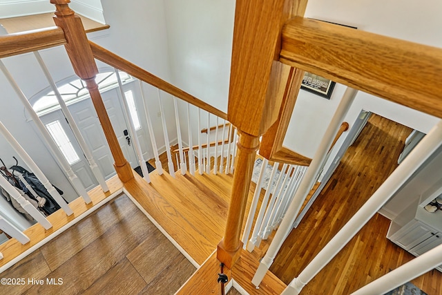 stairway featuring wood-type flooring