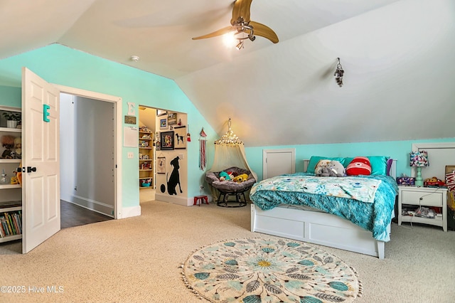 carpeted bedroom featuring ceiling fan and vaulted ceiling