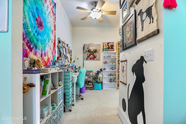 carpeted office space featuring ceiling fan