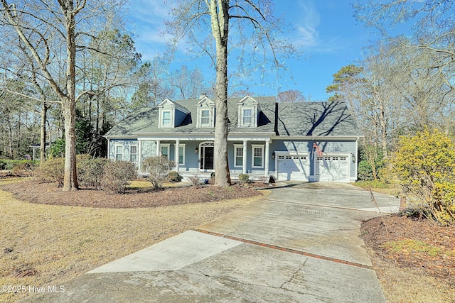 cape cod-style house with a garage and a porch