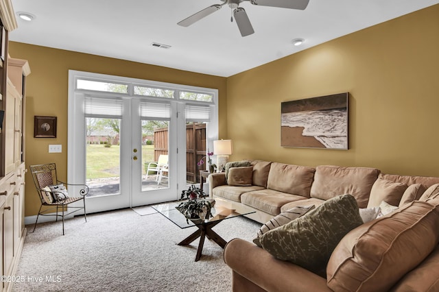 living room with french doors, light carpet, visible vents, and a ceiling fan