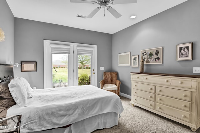 bedroom featuring access to exterior, visible vents, baseboards, light carpet, and a ceiling fan