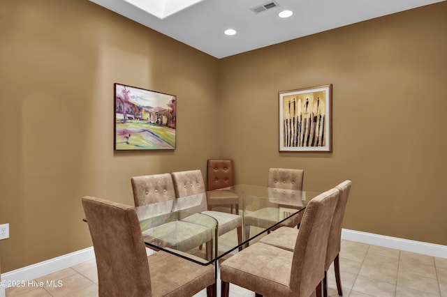 dining area with visible vents, baseboards, light tile patterned floors, recessed lighting, and a skylight