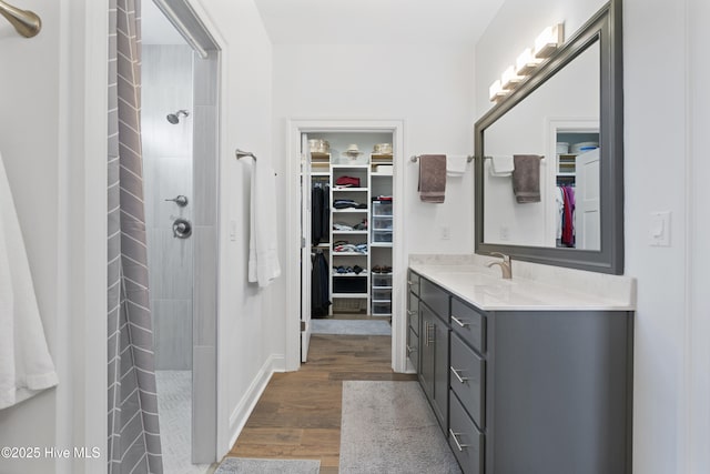 bathroom featuring a shower, wood-type flooring, and vanity