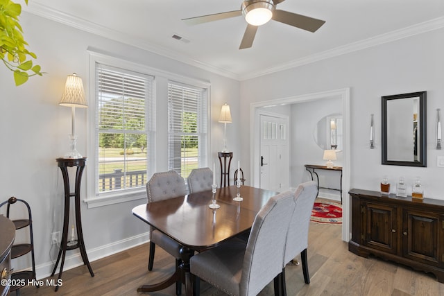 dining space featuring ceiling fan, light hardwood / wood-style floors, plenty of natural light, and crown molding