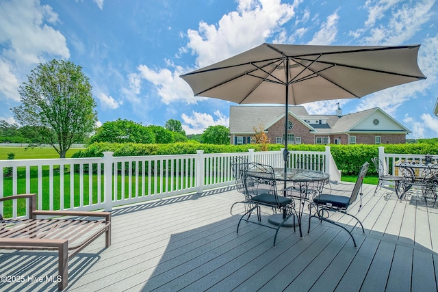 wooden terrace featuring a yard