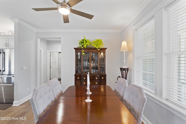 dining area featuring dark hardwood / wood-style flooring, ceiling fan, and ornamental molding