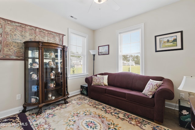 living room featuring plenty of natural light, ceiling fan, and wood-type flooring