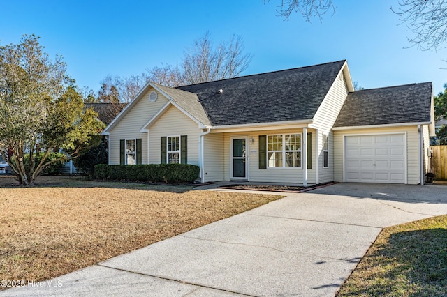 view of front of property featuring a garage and a front lawn