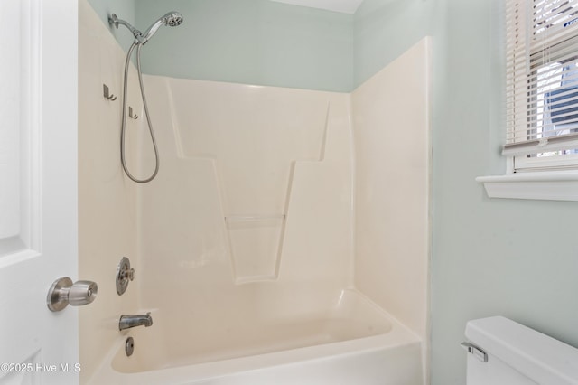 bathroom featuring shower / bath combination and toilet