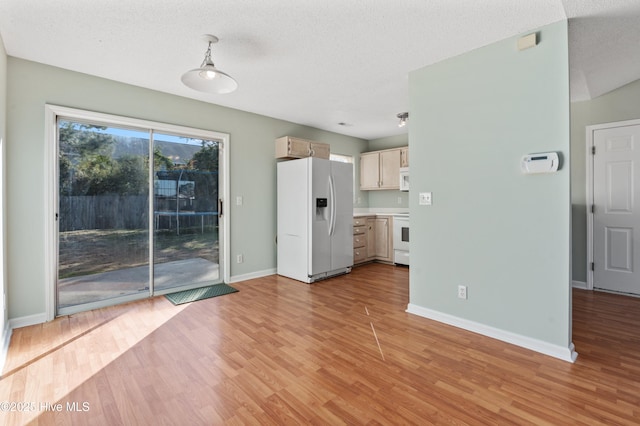 unfurnished living room with a textured ceiling and light wood-type flooring