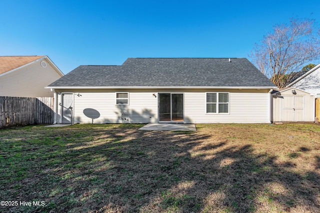 back of house featuring a storage unit and a yard