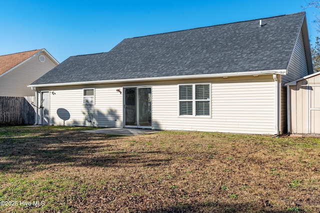 rear view of property featuring a yard and a patio