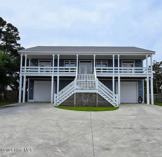 beach home featuring a garage and covered porch