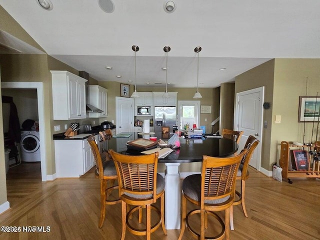 dining area with washer / clothes dryer and hardwood / wood-style floors