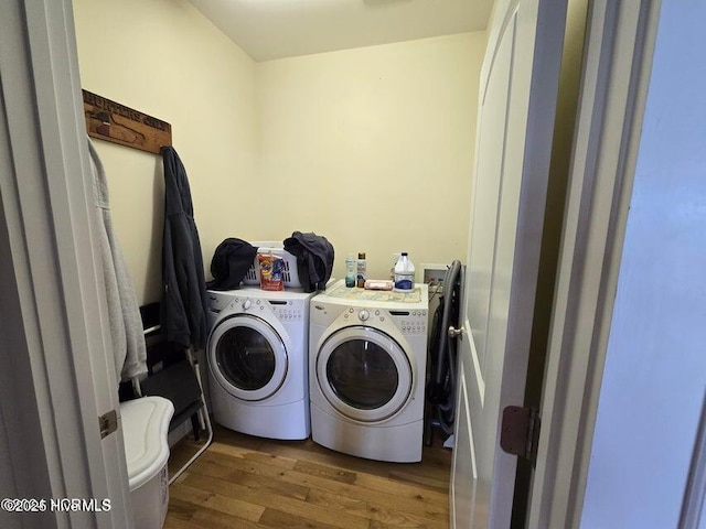 laundry area with wood-type flooring and independent washer and dryer