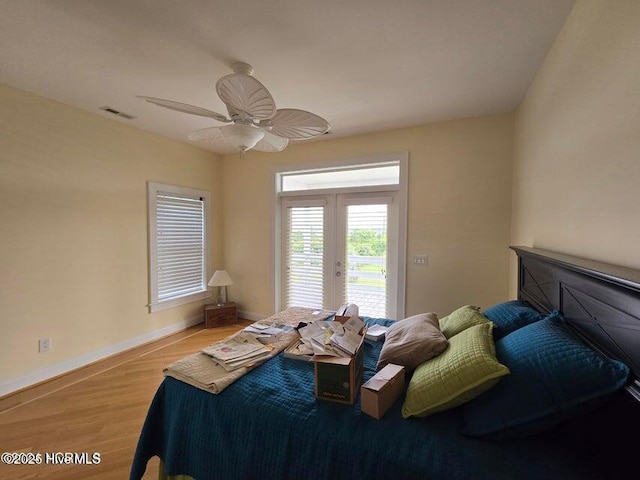 bedroom featuring french doors, ceiling fan, access to exterior, and light hardwood / wood-style floors