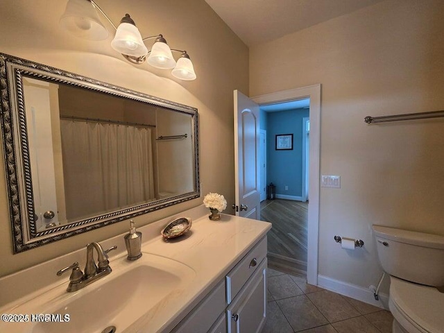 bathroom with tile patterned floors, vanity, and toilet