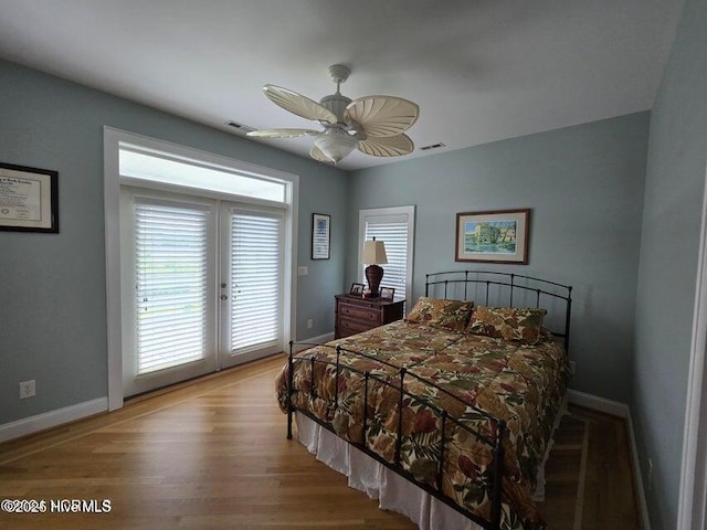 bedroom featuring french doors, ceiling fan, wood-type flooring, and access to exterior