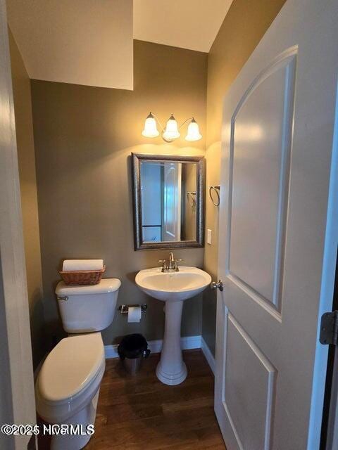 bathroom featuring hardwood / wood-style flooring, sink, and toilet