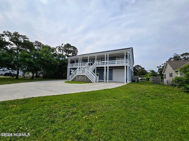 view of front of home with a garage, a porch, and a front yard