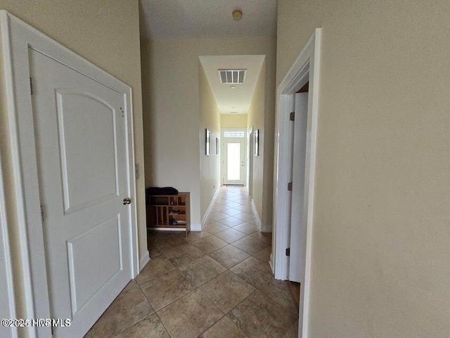 corridor featuring light tile patterned flooring