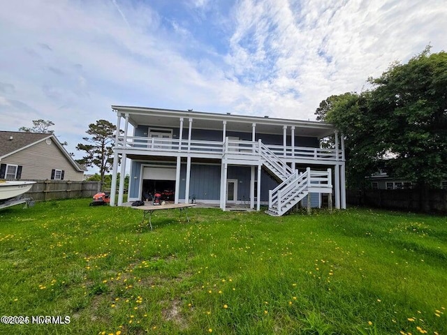 rear view of property with a deck and a lawn