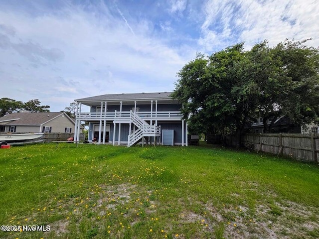 rear view of property with a yard