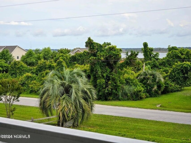 view of property's community featuring a water view and a yard