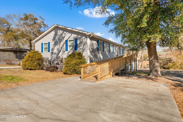 view of property exterior featuring a wooden deck