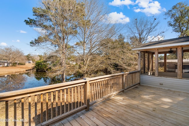 deck with a water view and a sunroom