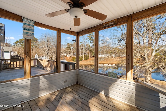 wooden deck featuring a water view and ceiling fan