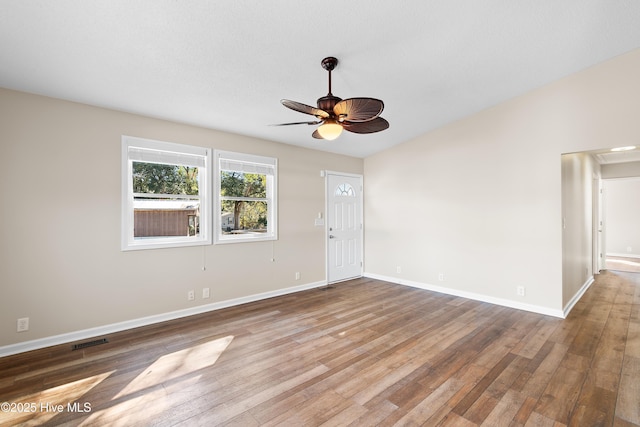 empty room with ceiling fan and wood-type flooring