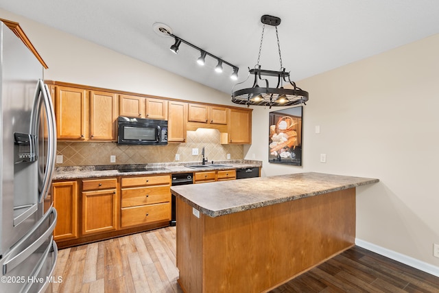 kitchen featuring decorative light fixtures, decorative backsplash, kitchen peninsula, and black appliances