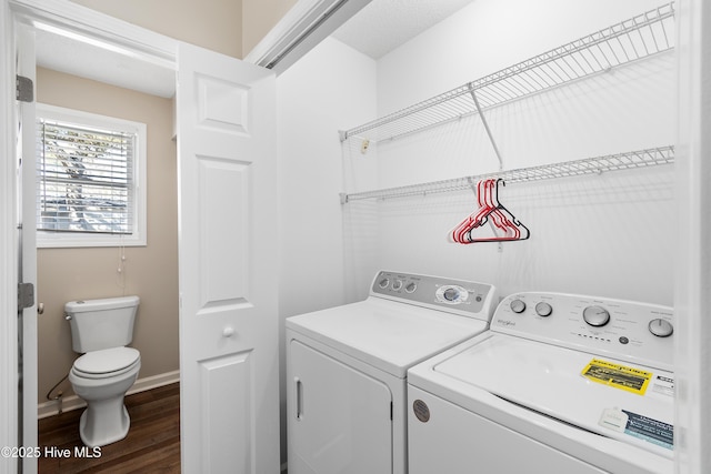 washroom with dark hardwood / wood-style flooring and washer and clothes dryer