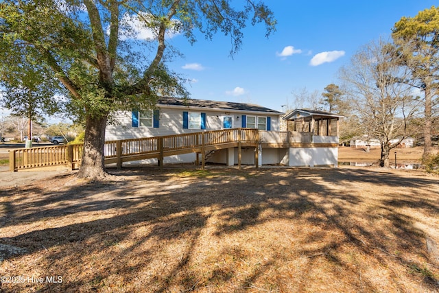 rear view of house featuring a deck