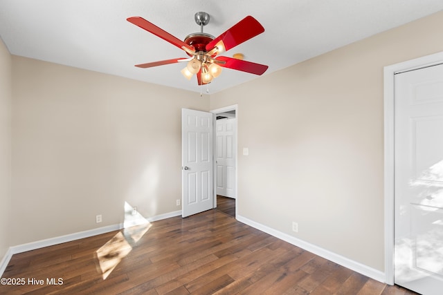 spare room with ceiling fan and dark hardwood / wood-style floors