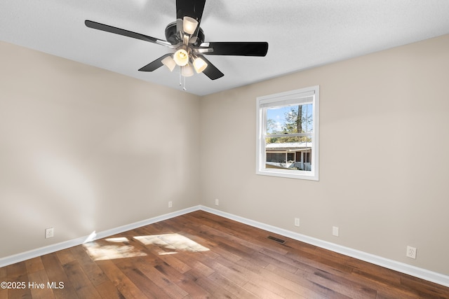 empty room featuring hardwood / wood-style flooring and ceiling fan